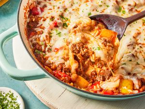 spoonful of unstuffed pepper lifted from skillet with more 