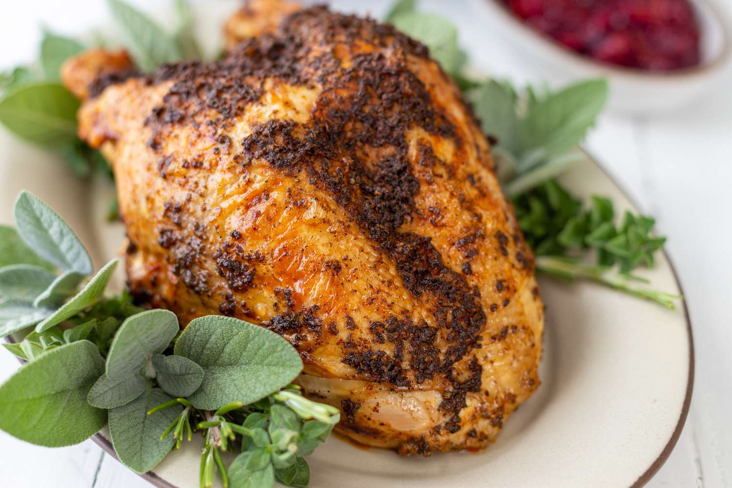 Quick and easy instant pot turkey breasts set on an herb covered platter.