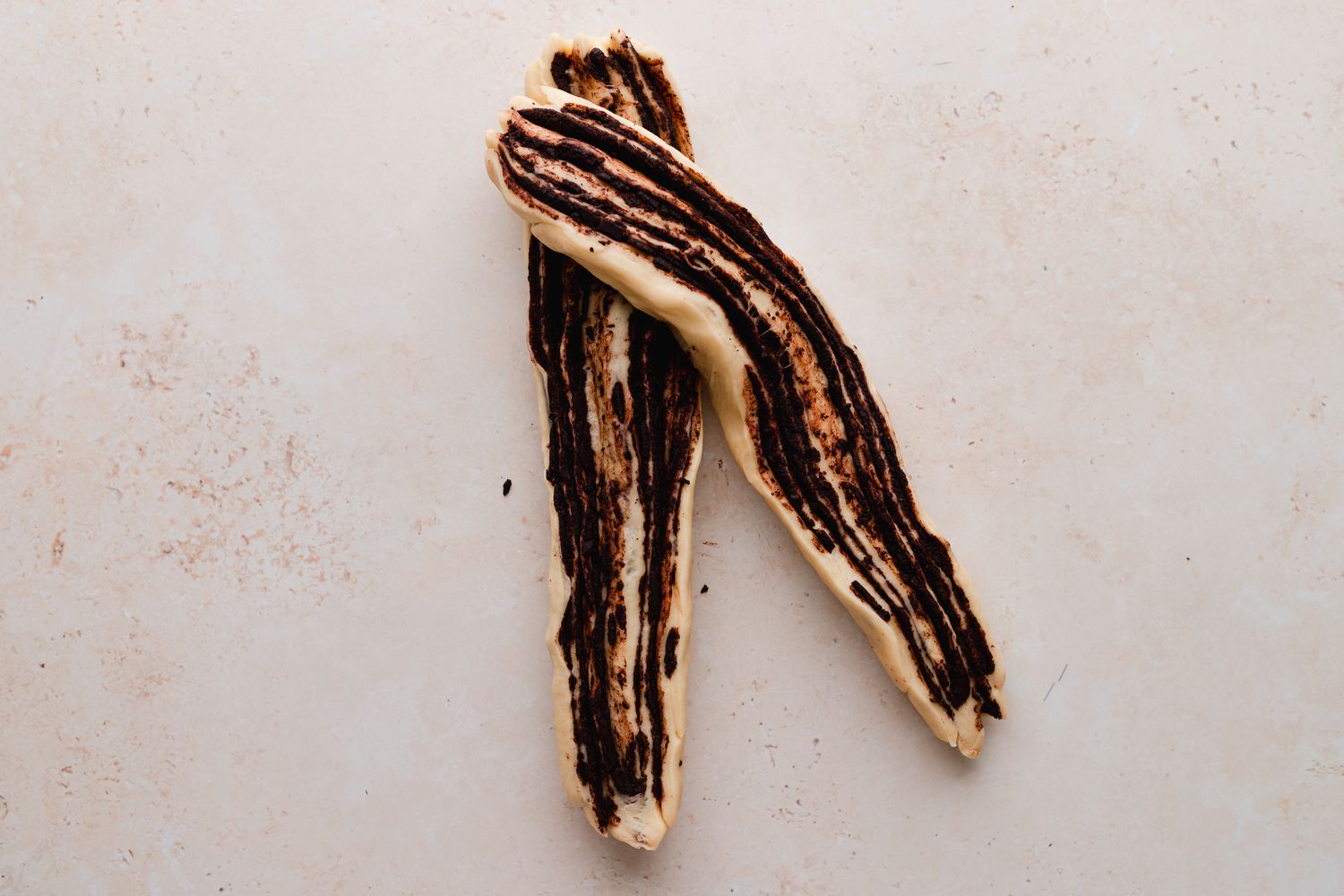 Braiding chocolate babka bread.