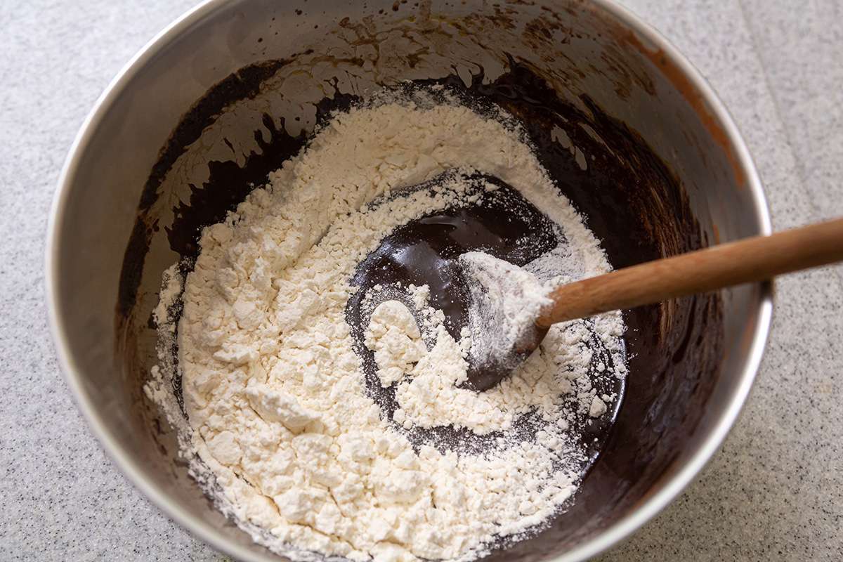 Flour added to chocolate mixture to show how to make brownies.