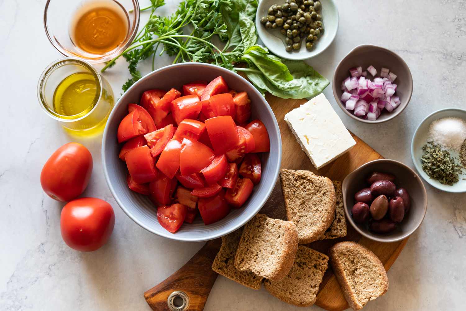 Ingredients in bowls to make Authentic Cretan salad.