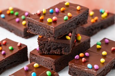 Stack of Homemade Cosmic Brownies and more on the counter around it