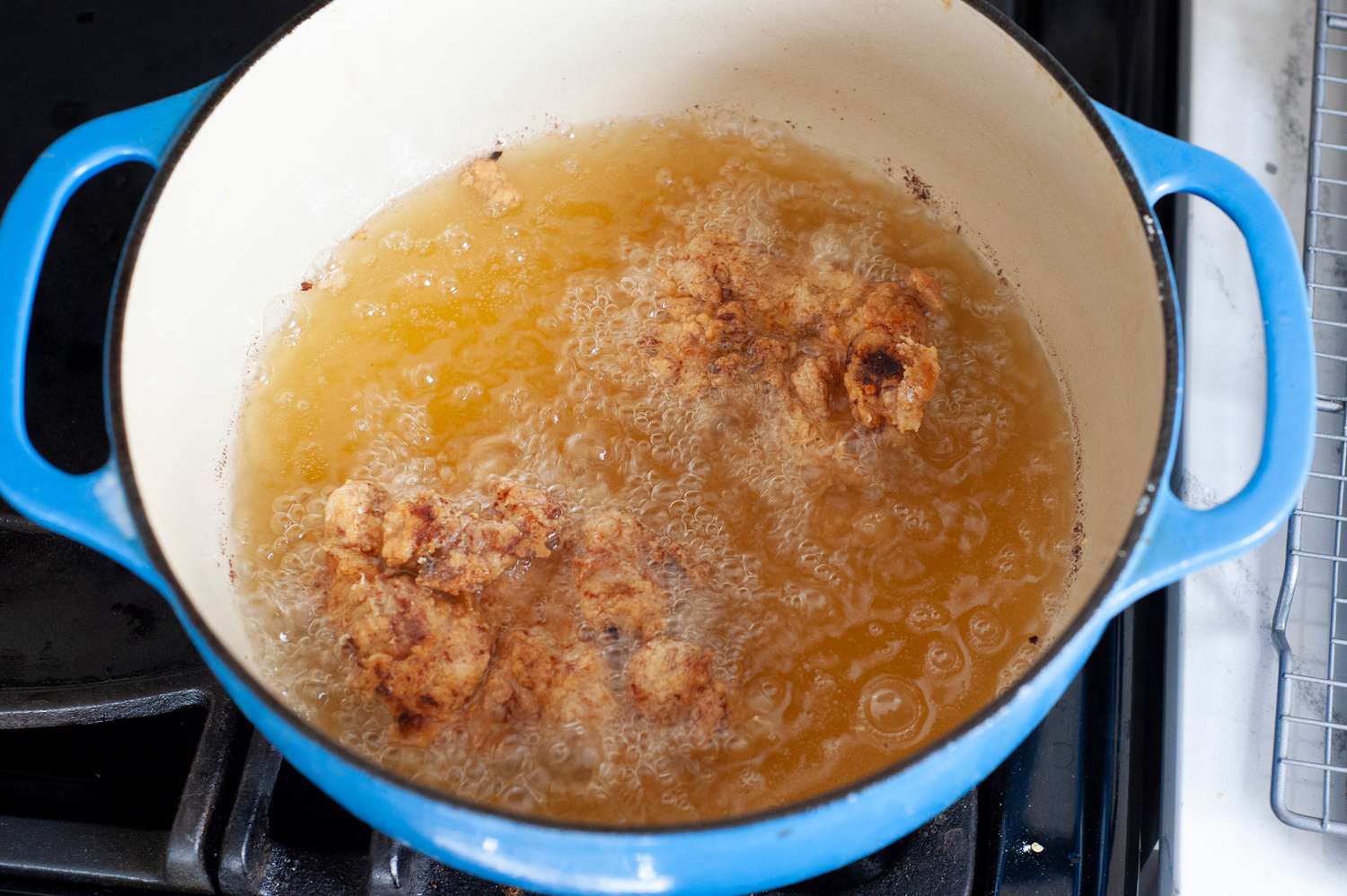 Chicken frying in a Dutch oven