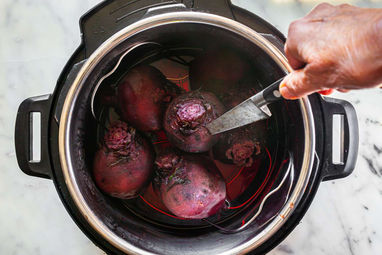 Beets in a Pressure Cooker with One Pierced with a Knife for Beet Chutney