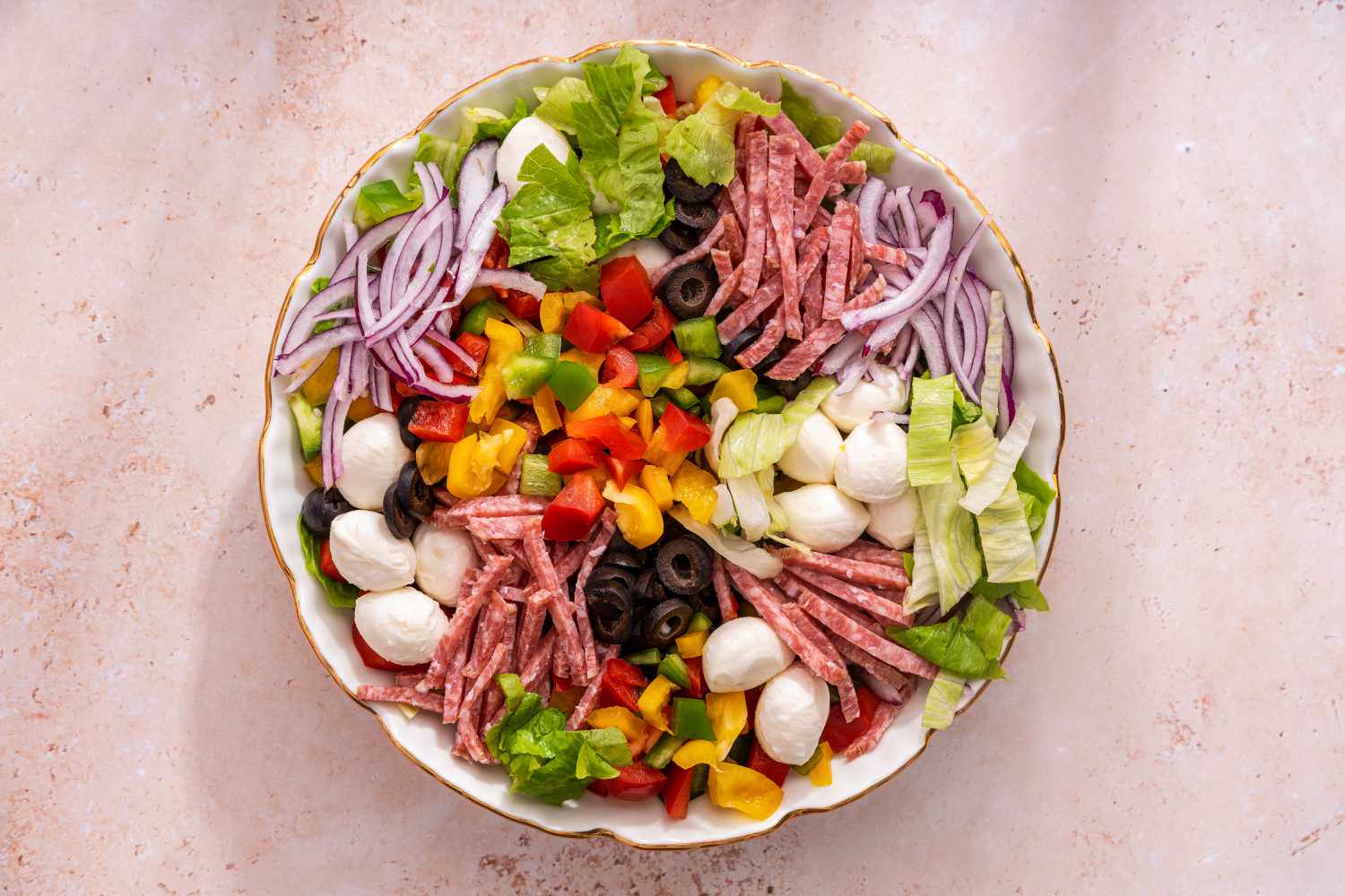 Bowl of Pizza Salad With Each Ingredient in Separate Mounds in the Bowl