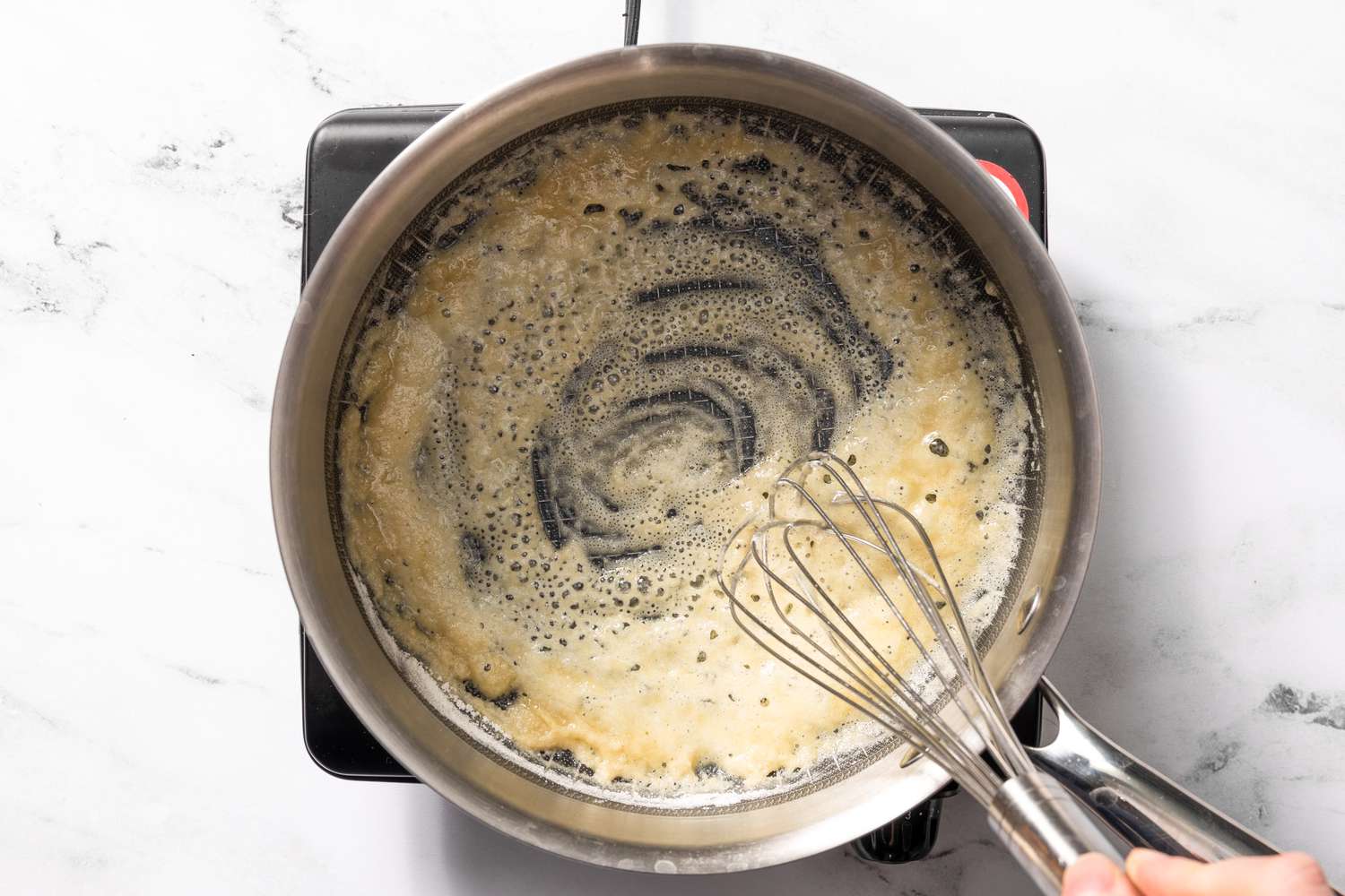 Roux whisked on a pot for welsh rarebit recipe