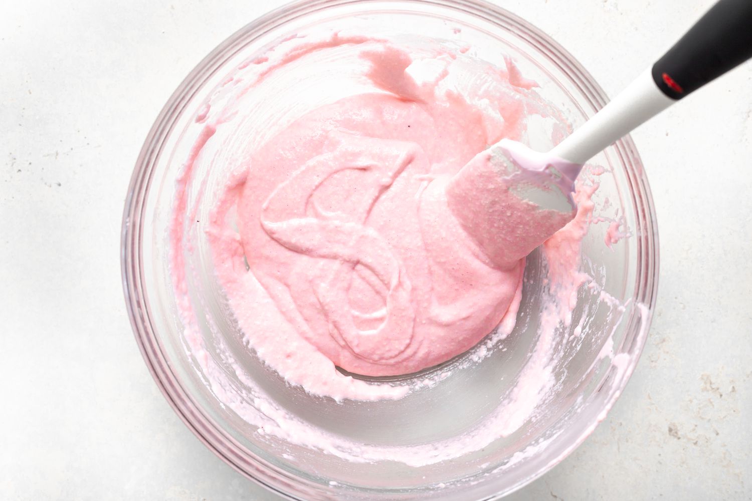 Mixing strawberry mixture and checking it passes the figure 8 test.