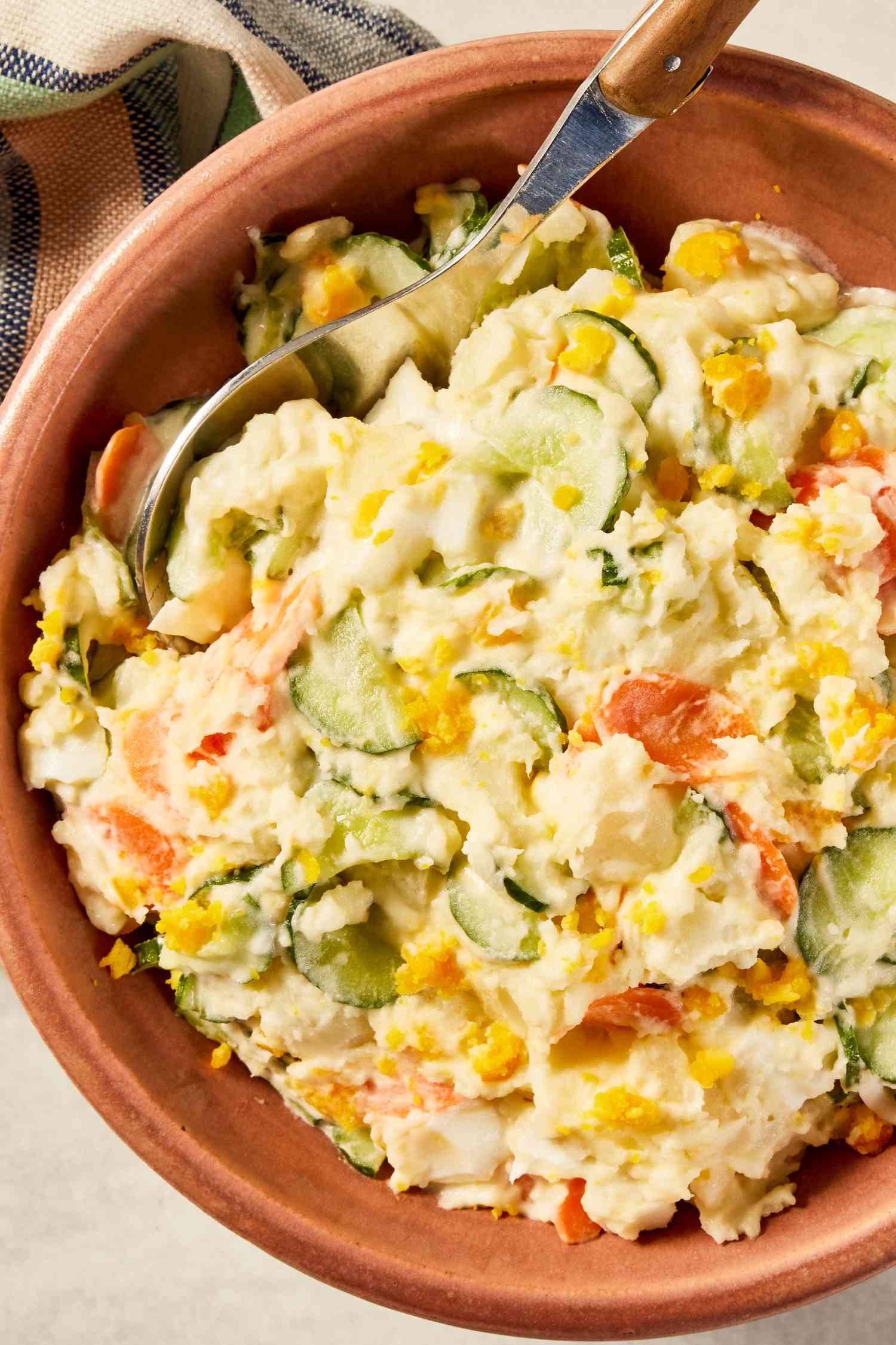 Korean-style potato salad in a bowl next to a table napkin