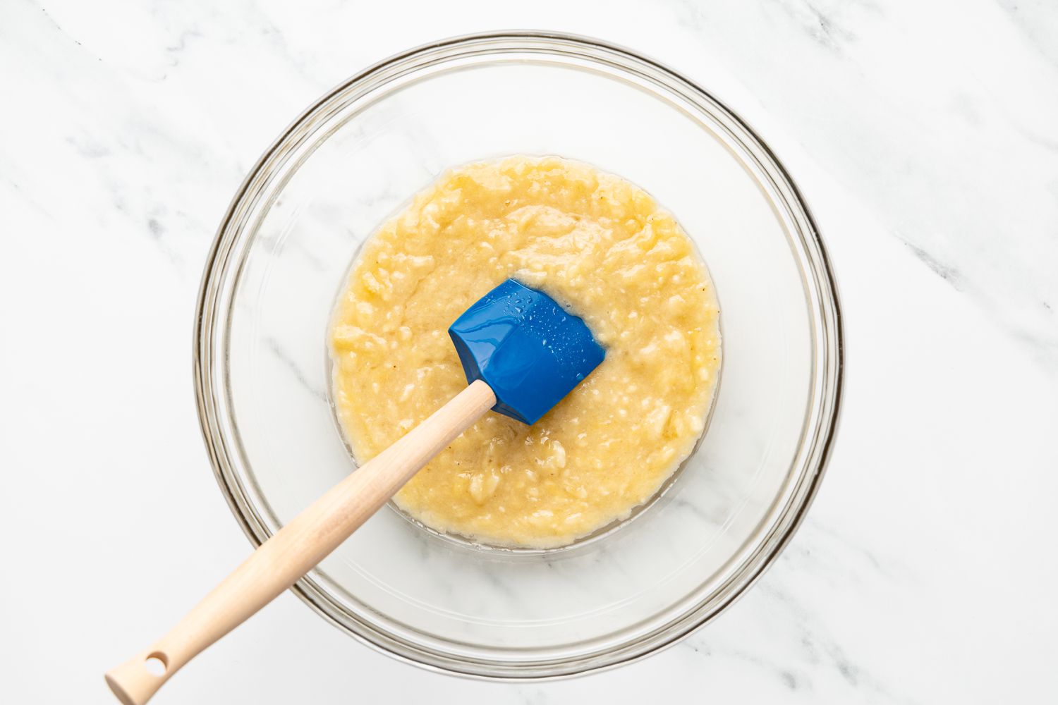 Bowl of Mashed Bananas With a Spatula for Banana Bread Cake Recipe