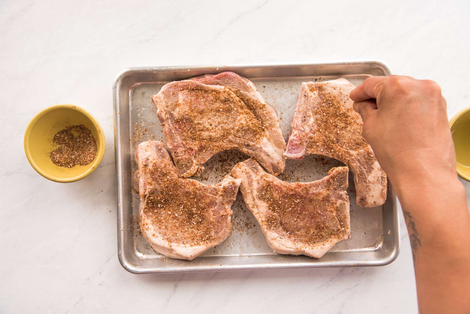 Sprinkle Seasoning on Pork Chops in Tray
