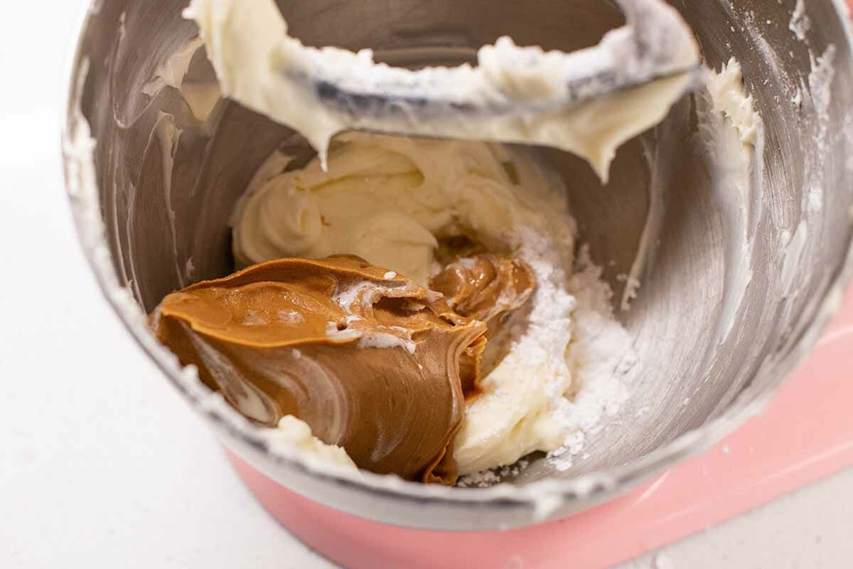 Adding peanut butter to the whipped cream to make a Peanut butter pie recipe.