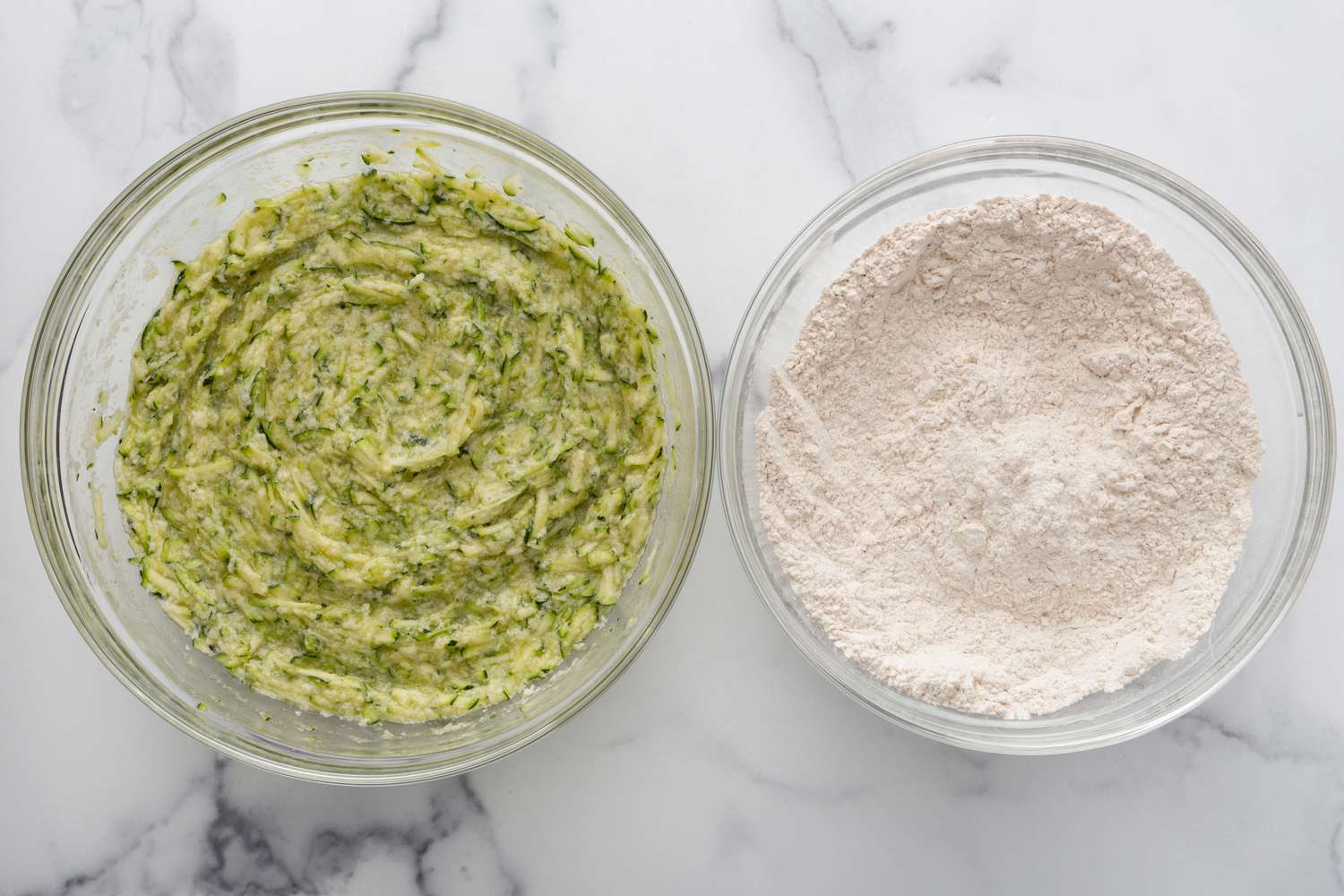 Zucchini mixture and flour mixture in set side by side in glass bowls