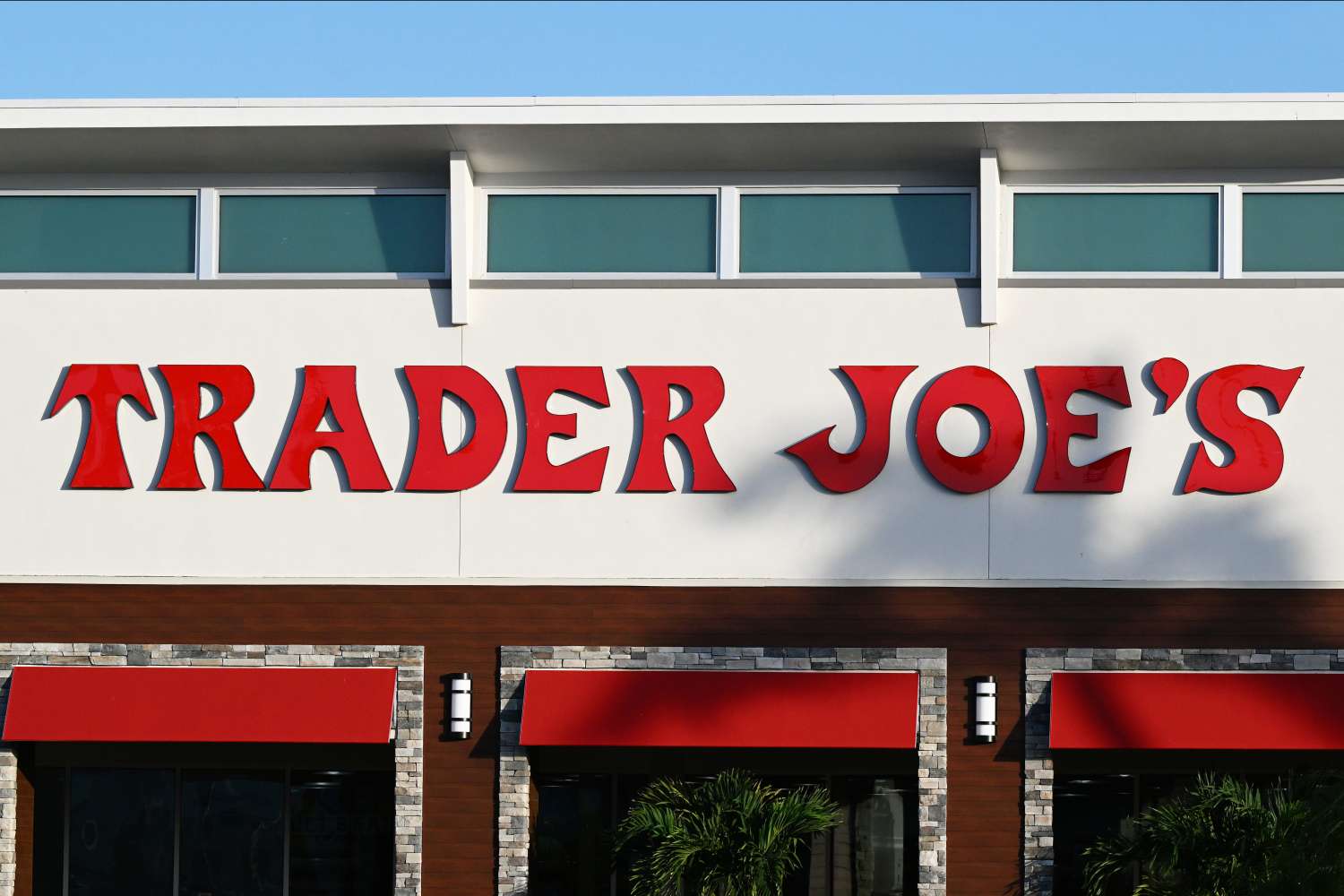 The front facade of a Trader Joe's store showing the store's name