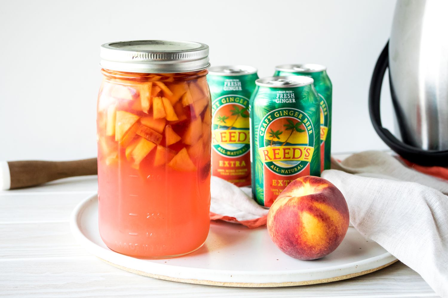 Jar of Rum Punch Surrounded by Peach and Ginger Beer