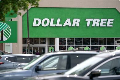 Storefront with Dollar Tree sign visible above parked cars
