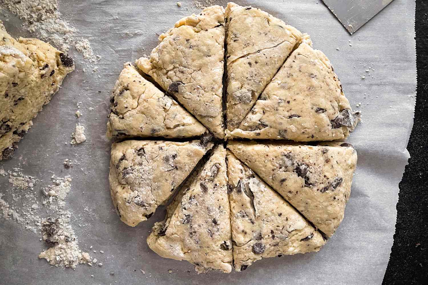 Scone dough cut into eight triangular sections ready for baking