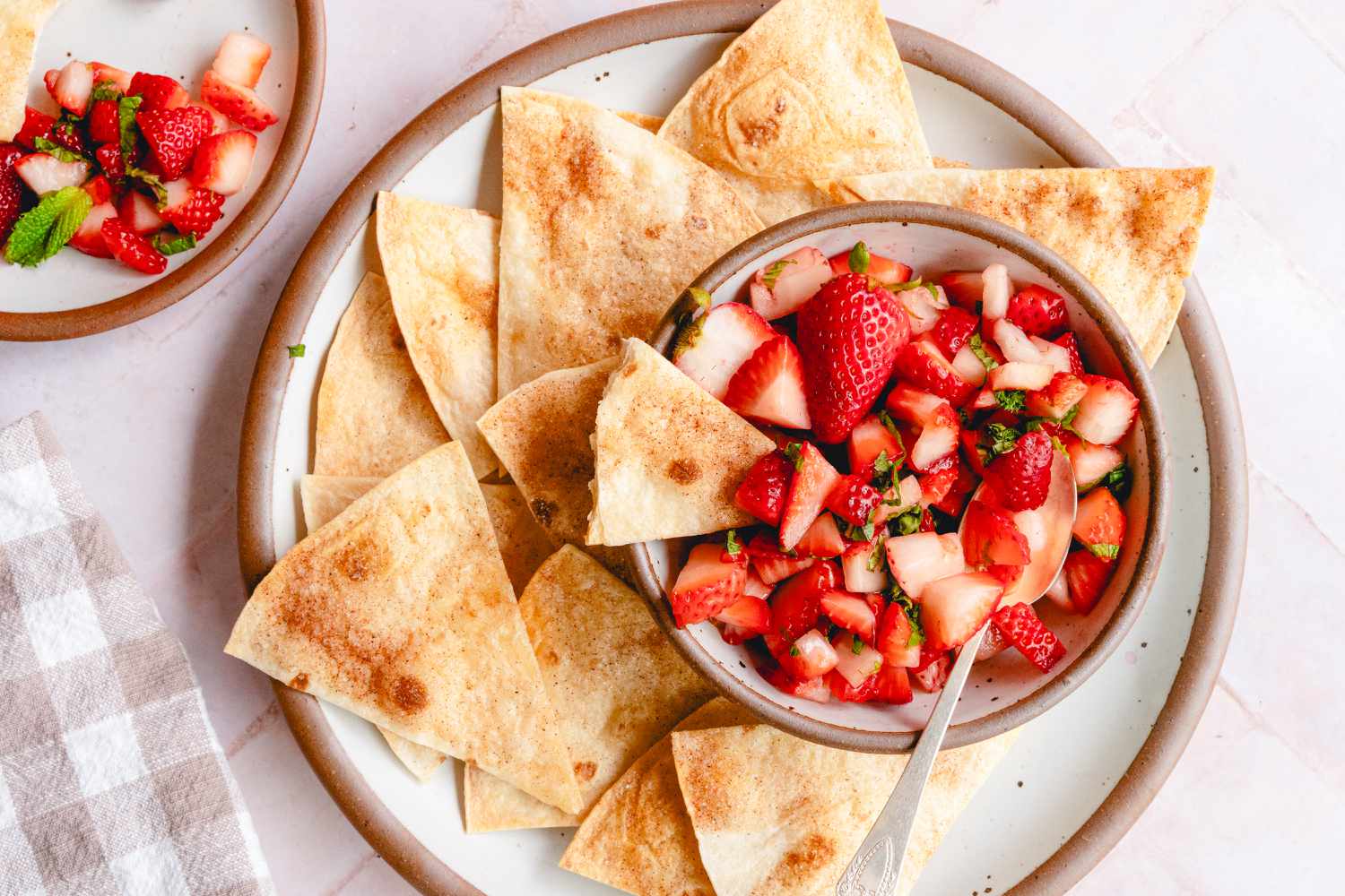 Strawberry salsa served with tortilla chips on a plate