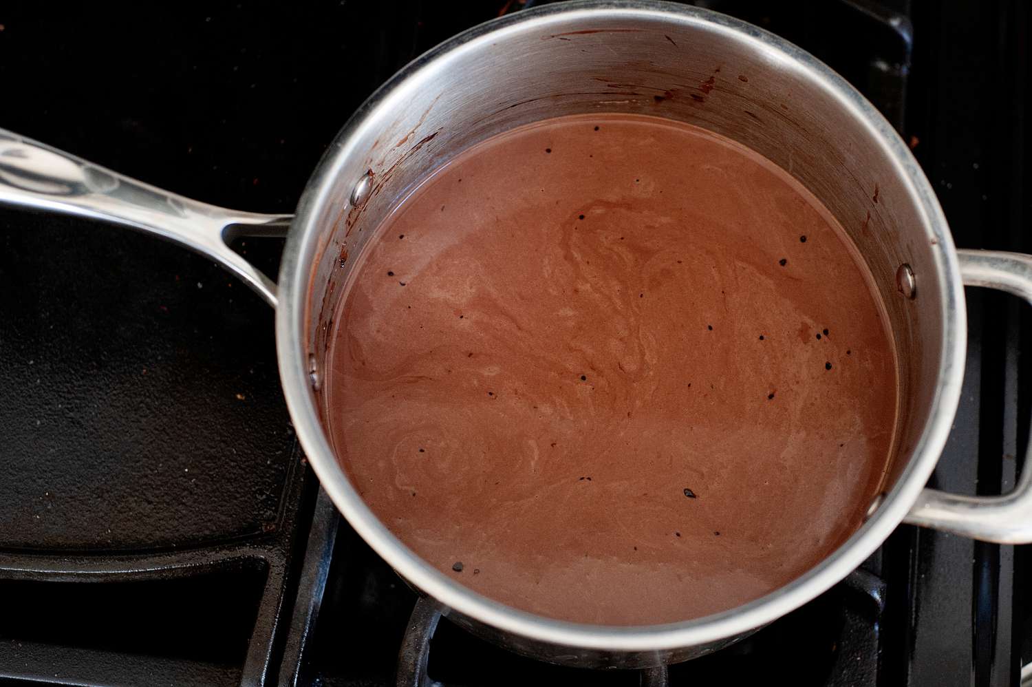 Melted chocolate in a saucepan to make a chocolate ice cream recipe.