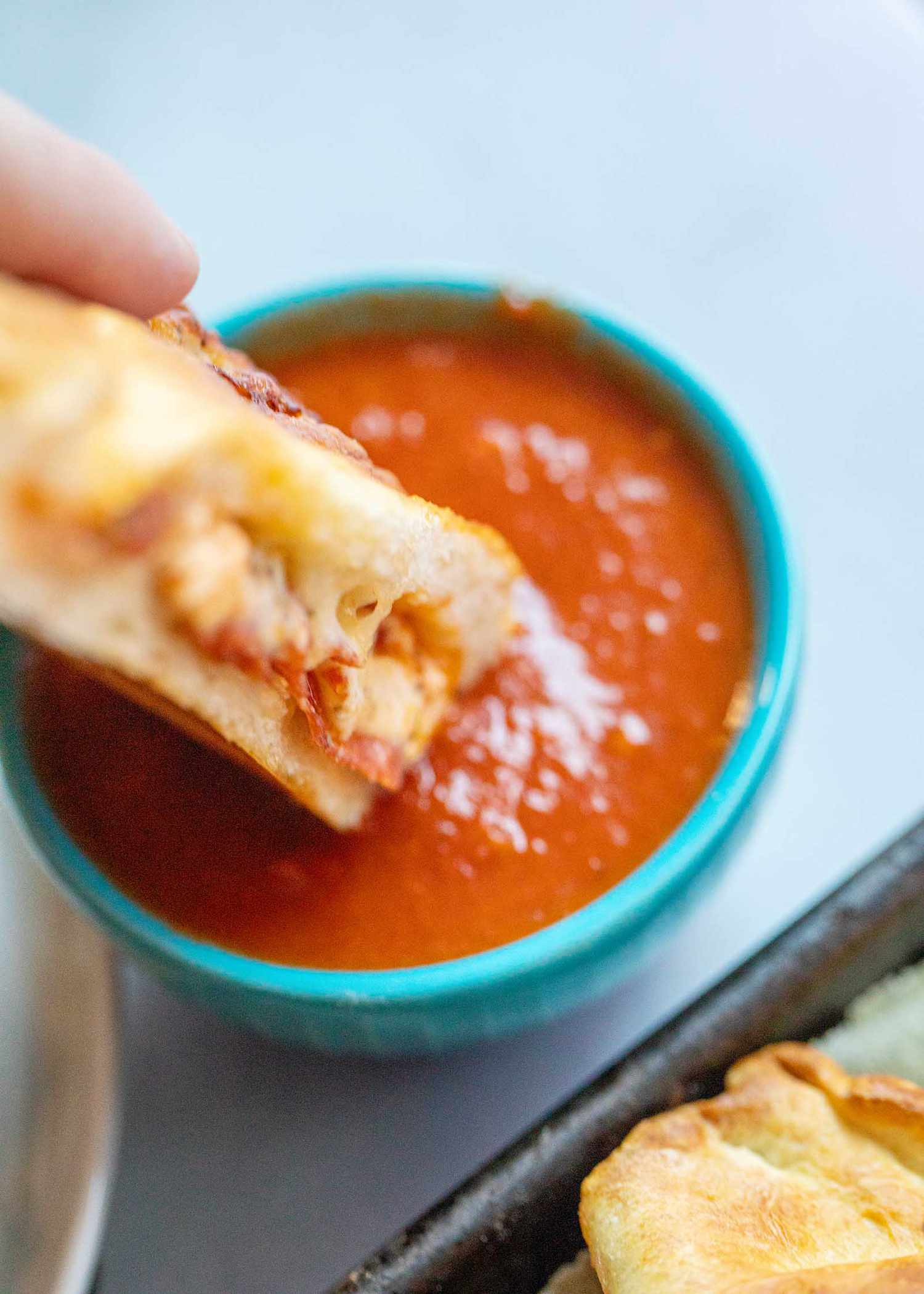 Calzone dipped in pizza sauce