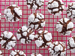 Chocolate crinkle cookies on a hot pink cooling rack