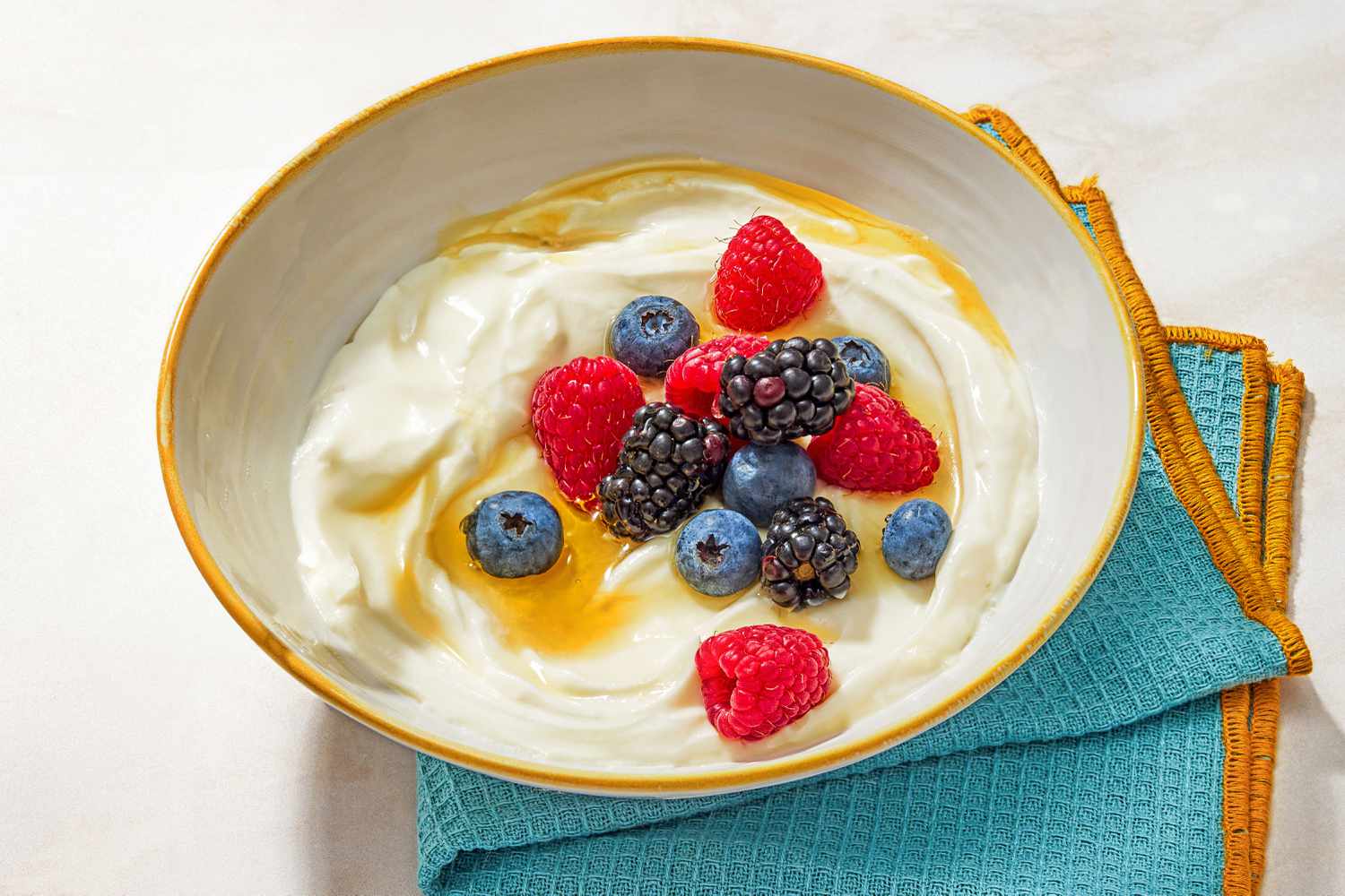 A bowl of Whipped Ricotta and Berries with a napkin