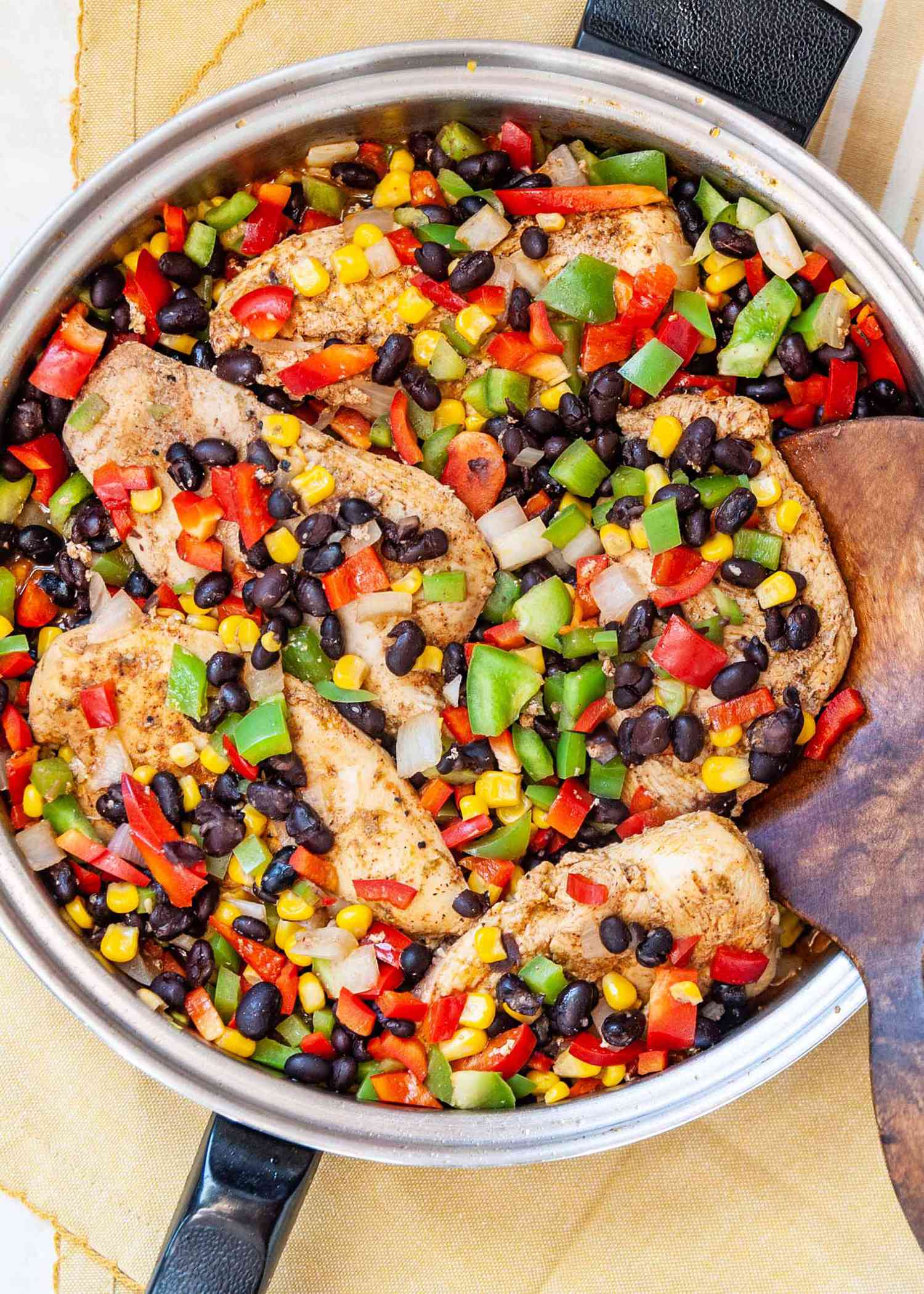 Skillet with chicken and mixed vegetables including beans corn peppers and onions