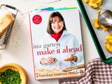 Ina Gartens cookbook titled Make It Ahead displayed on a table with cooking ingredients