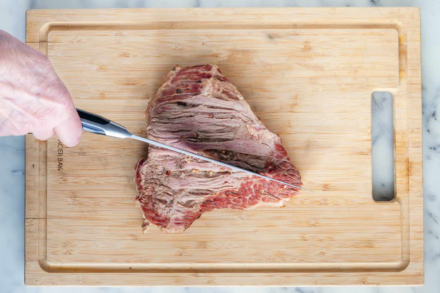Cutting corned beef for New England Boiled Dinner