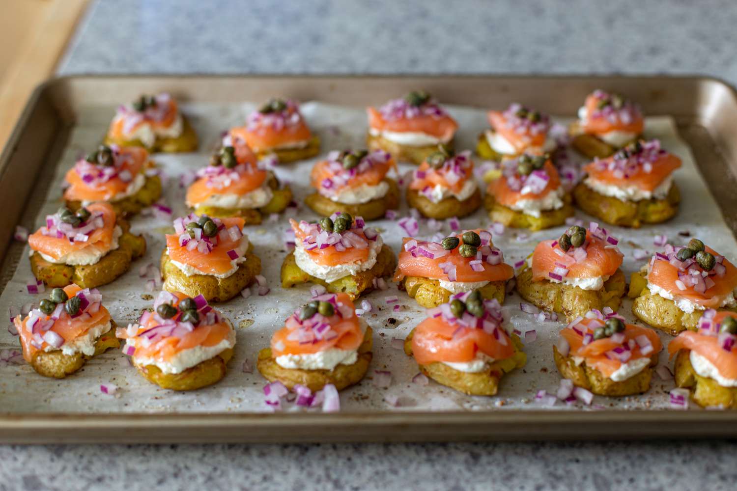 Easy potatoes with smoked salmon assembled on a baking sheet.