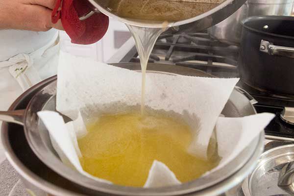 Straining chicken stock through paper towels