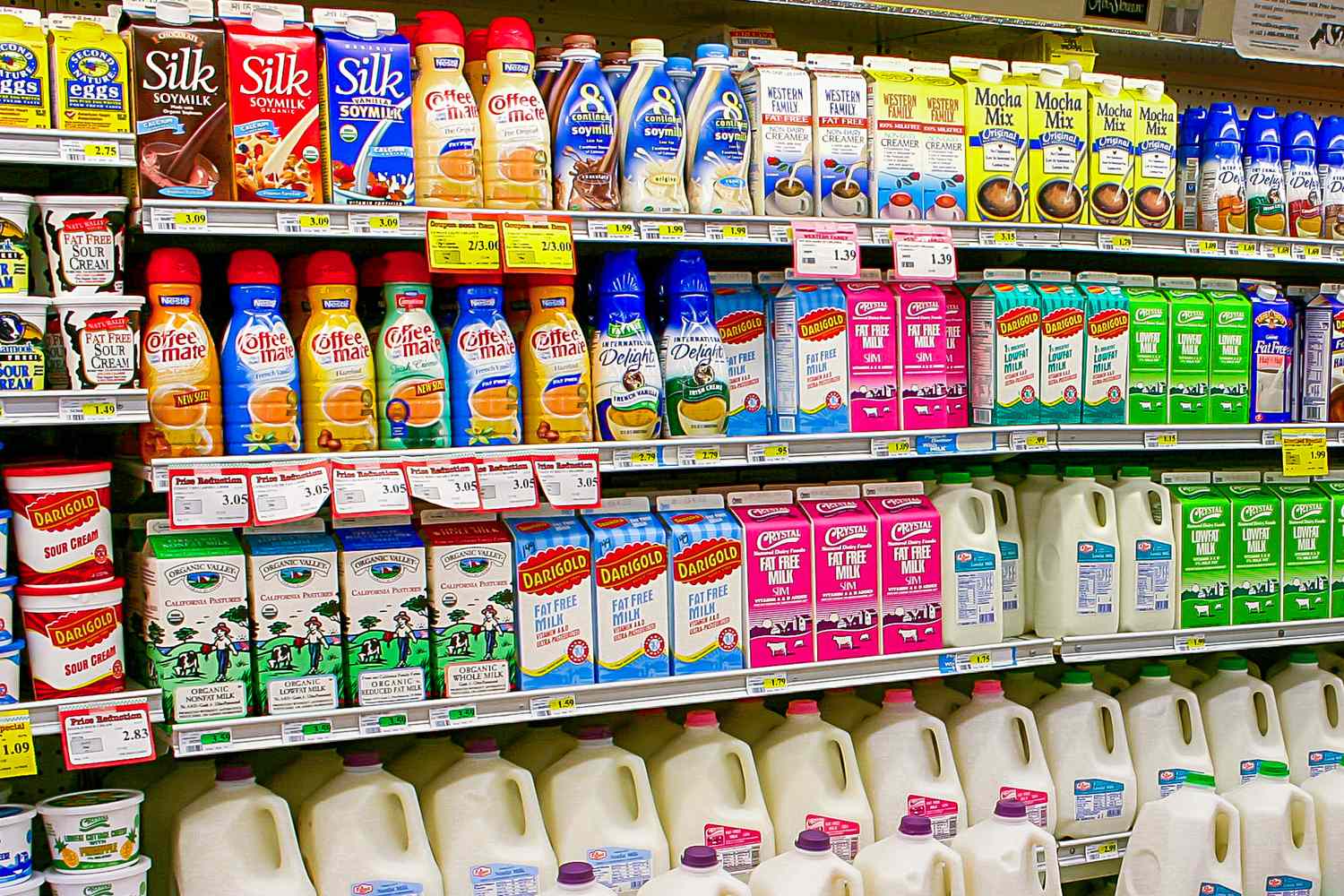 Grocery store aisle with various coffee creamers and milk products on shelves