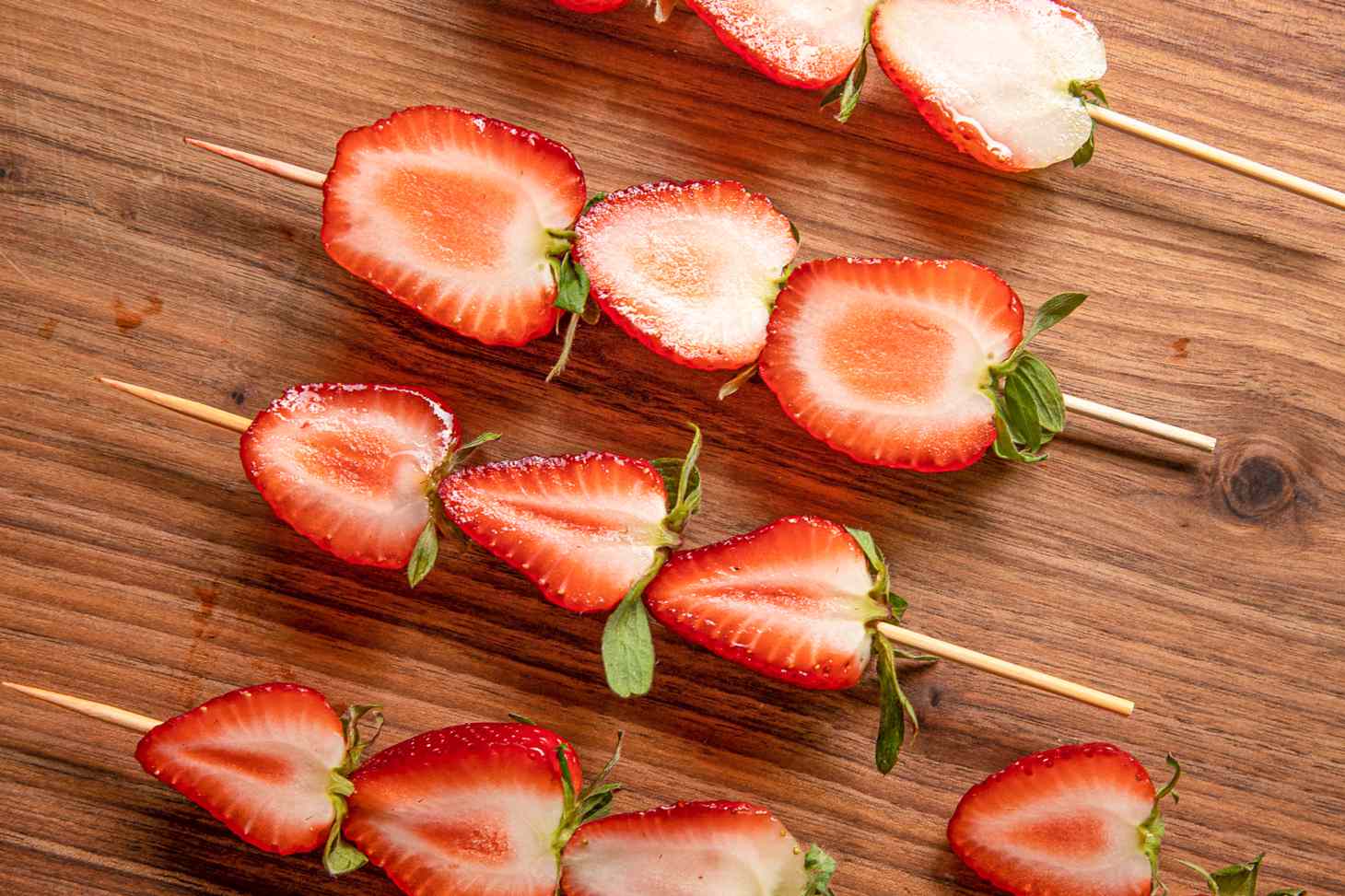 Skewered Halved Strawberries on a Cutting Board