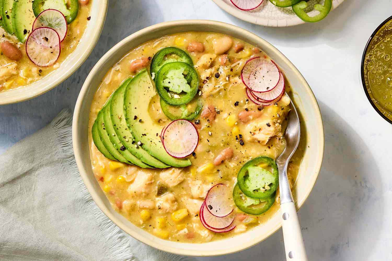overhead view of a bowl of Dump-and-Stir White Chicken Chili with a spoon