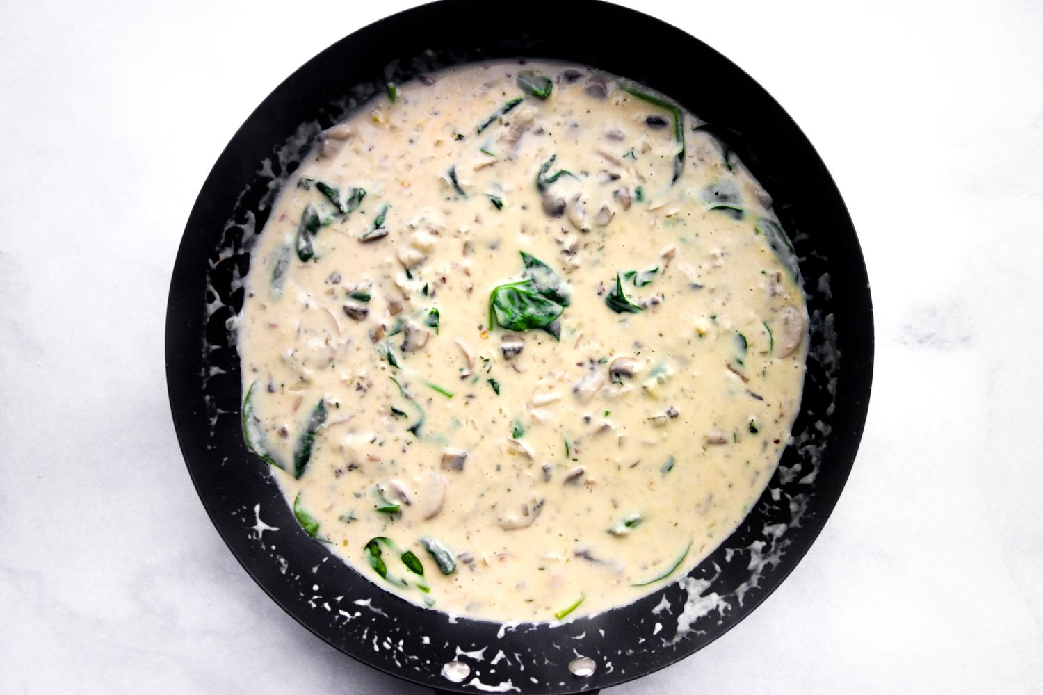 Add spinach and thicken sauce.