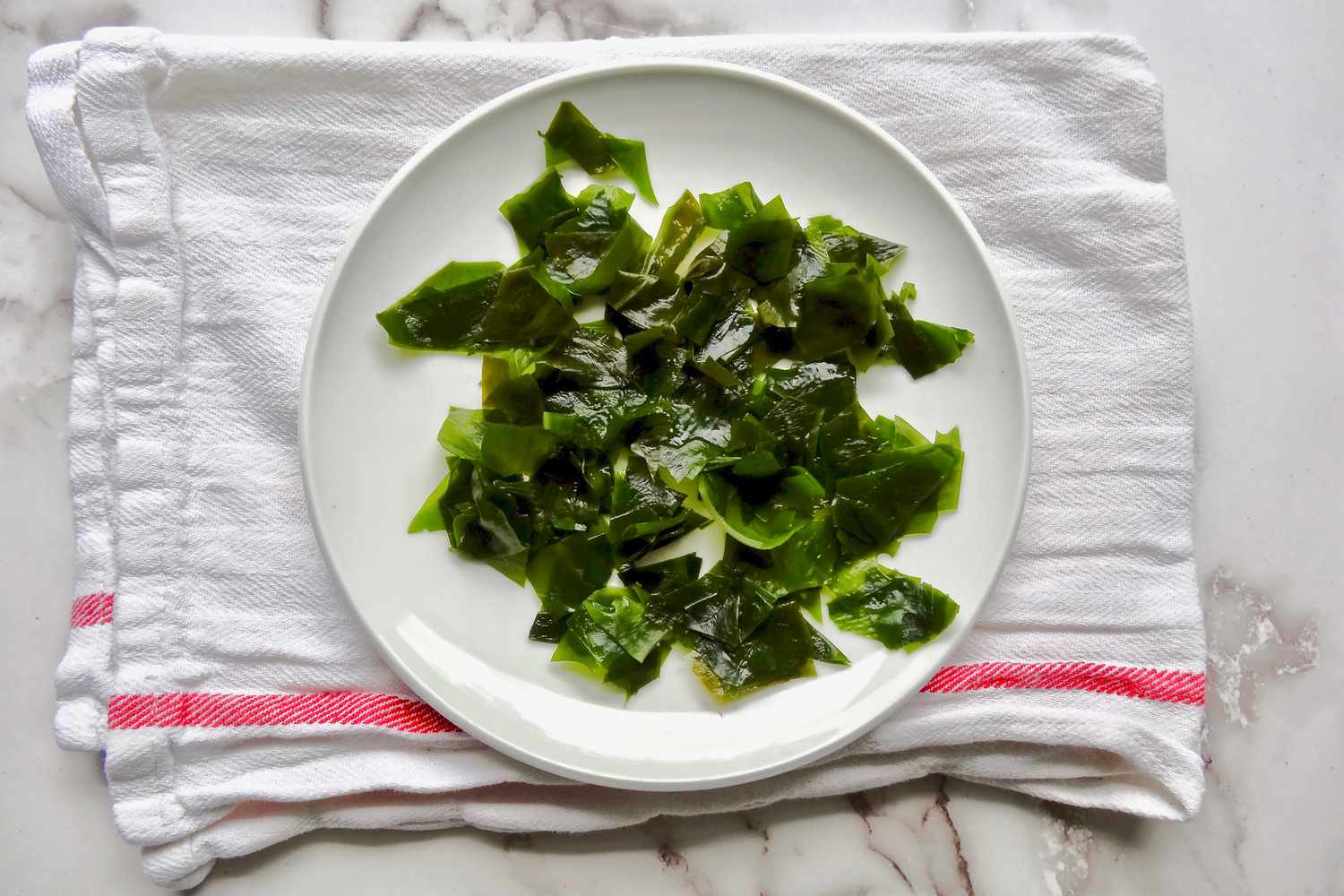 Dried and chopped wakame on a plate to make homemade miso.
