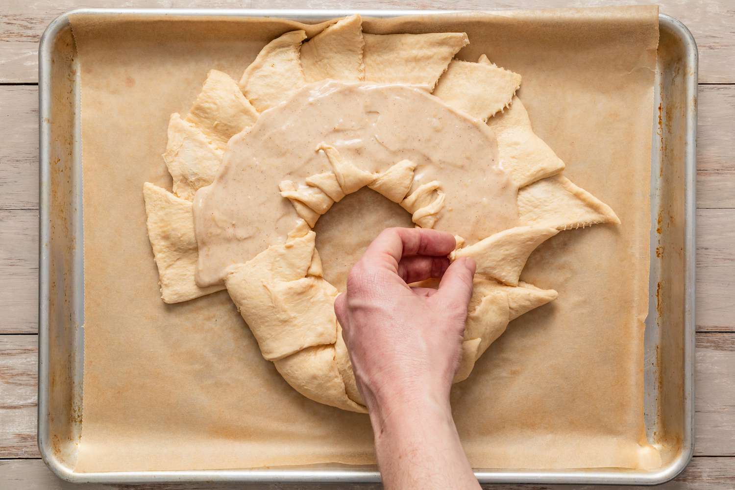 outer edges of dough folded over to create the king cake shape