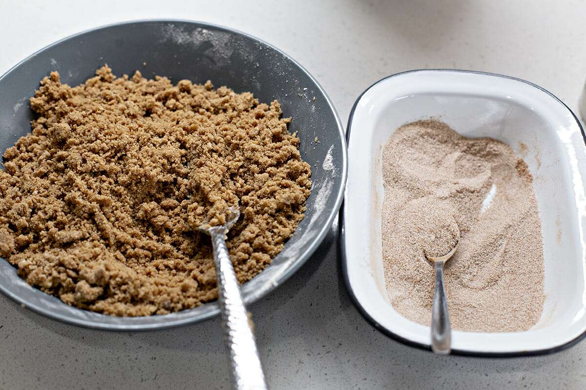 Strusel topping in a bowl to the left and a cinnamon and sugar mixture to the right