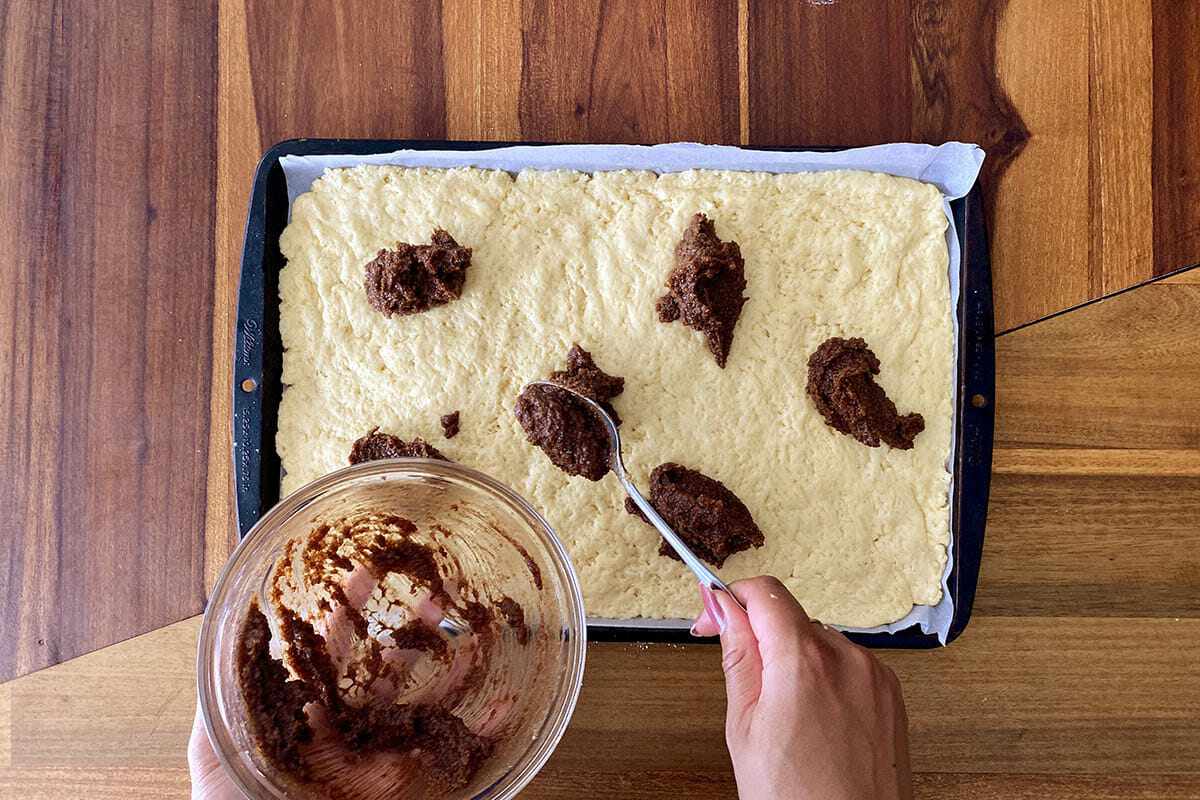 Cinnamon mixture dolloped on the dough to make easy gluten free cinnamon rolls.