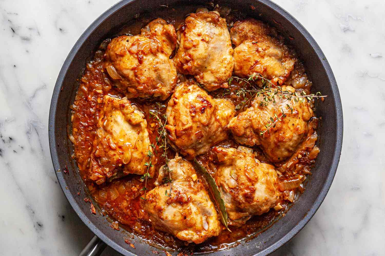 Making Southern smothered chicken recipe in a skillet.