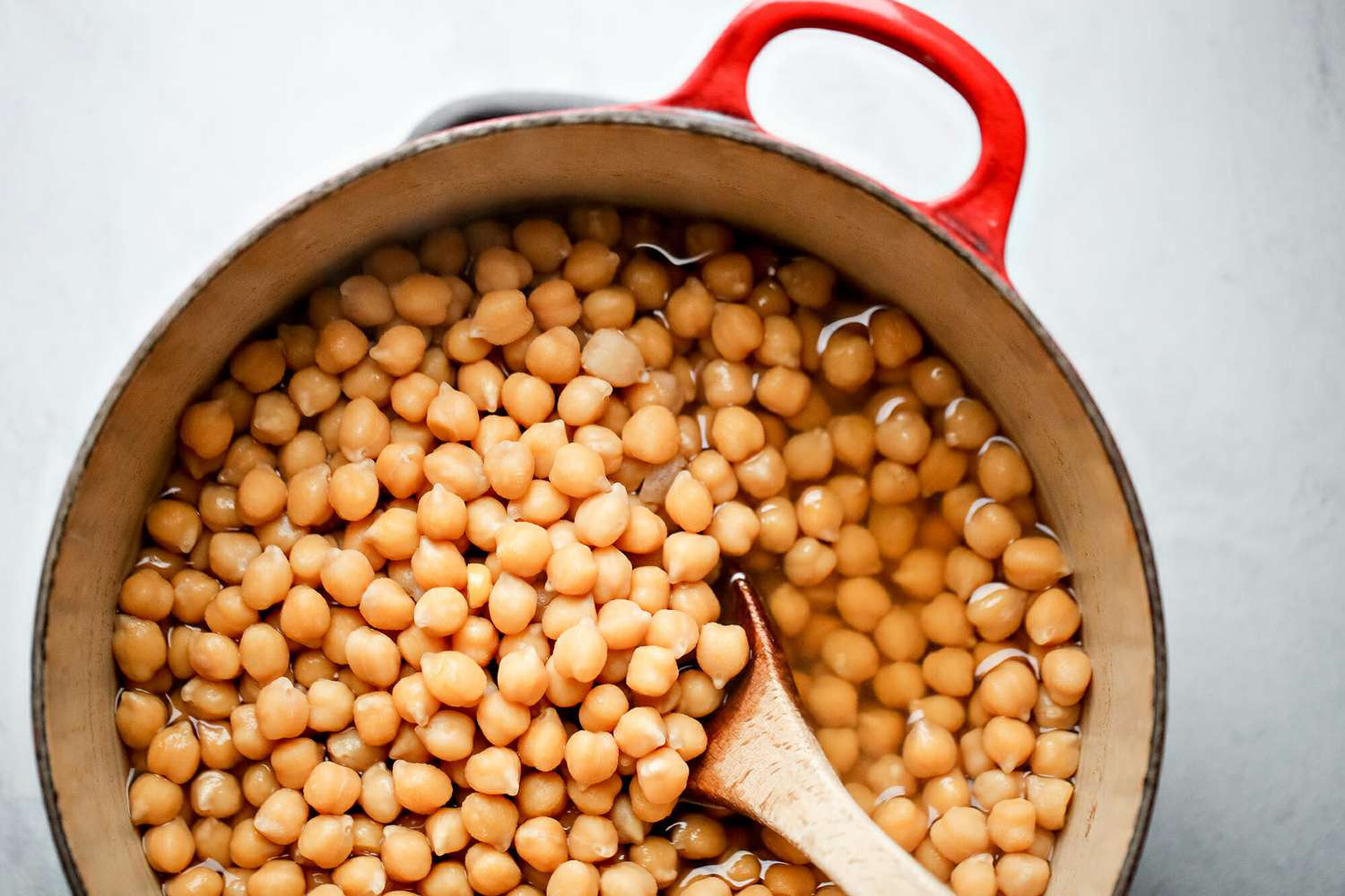 Chickpeas in a pot with a wooden spoon