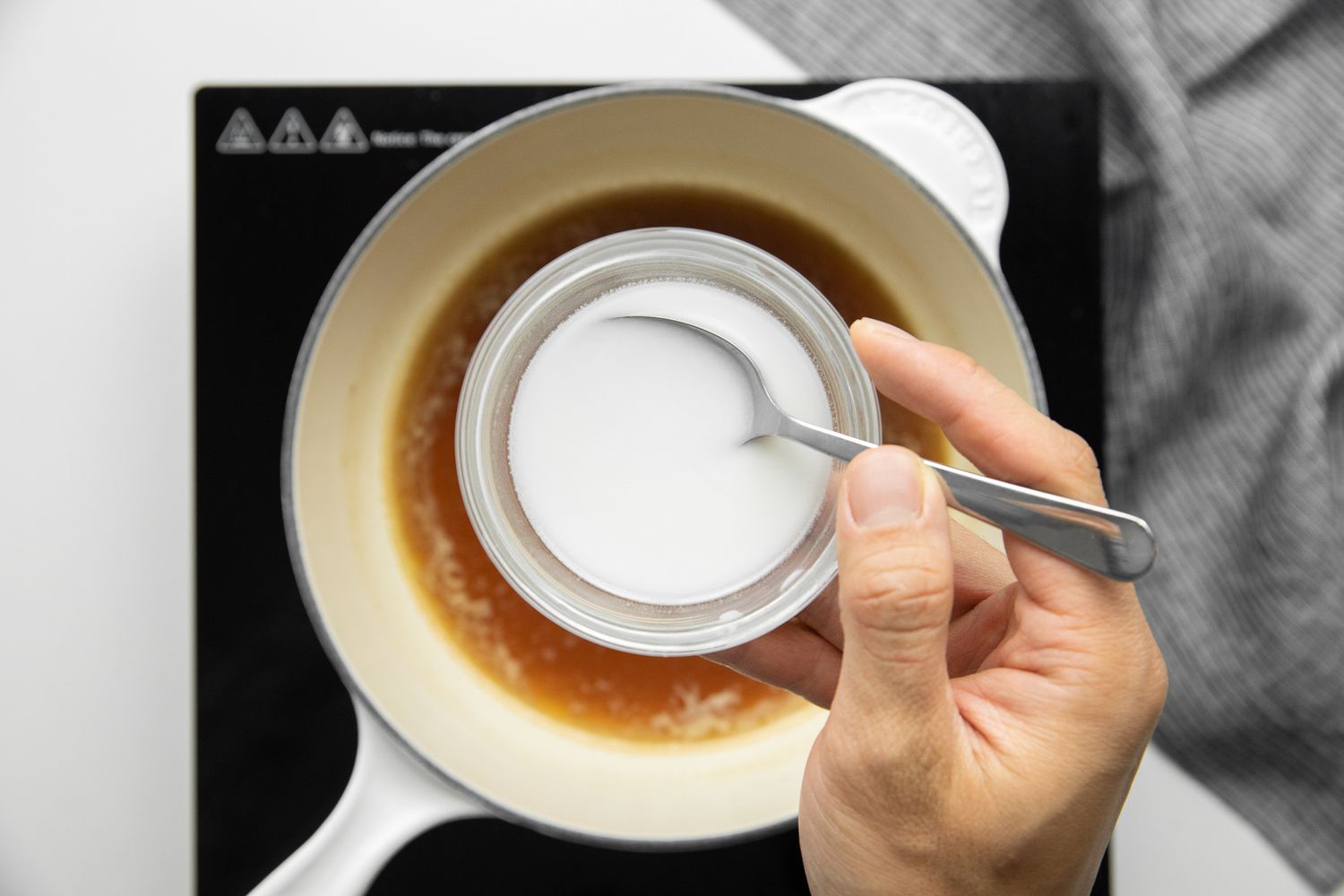 Hand Holding Cornstarch Slurry for Egg Foo Young