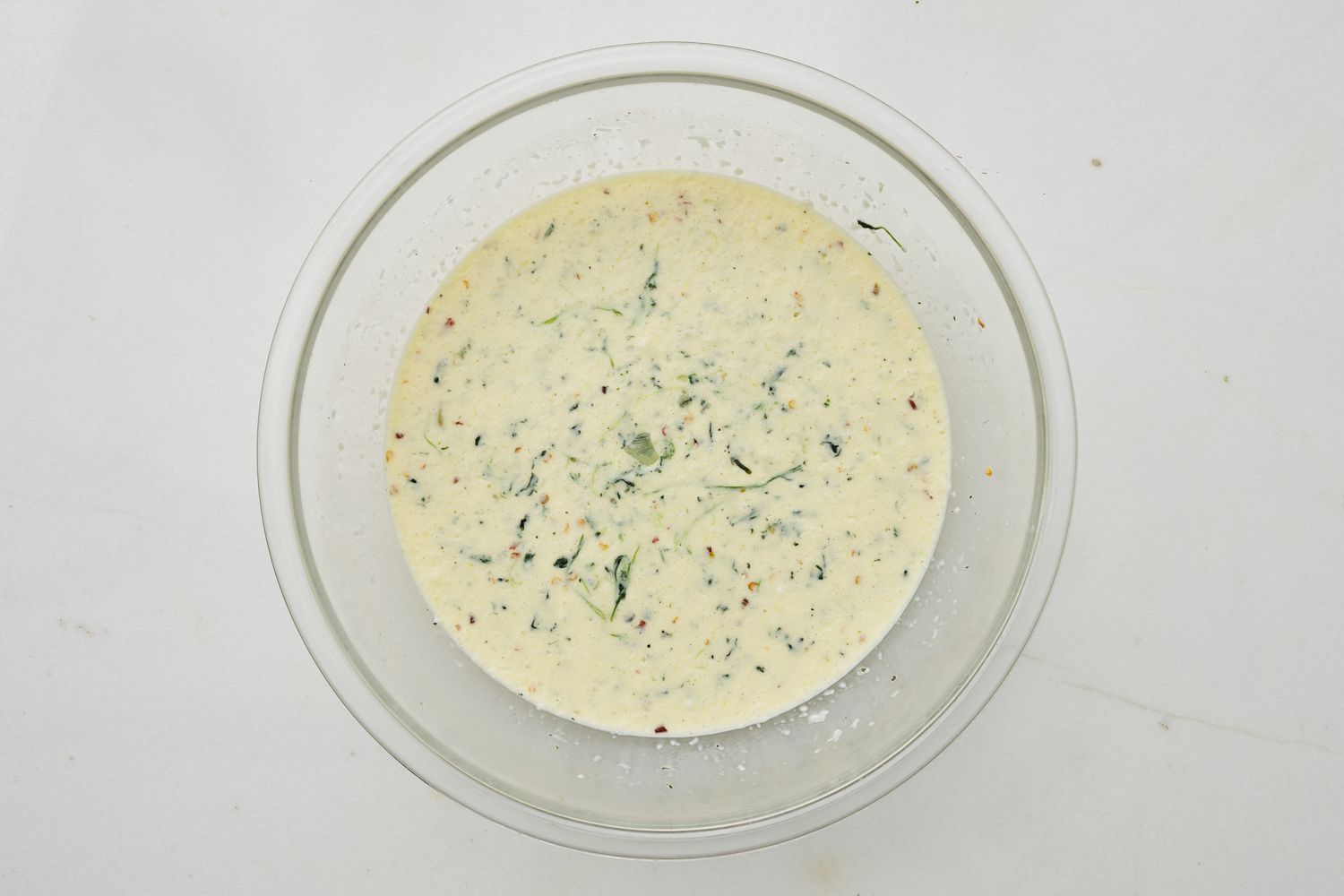 Wet ingredients mixed with reserved spinach (1/4) for spinach flornetine breakfast casserole recipe