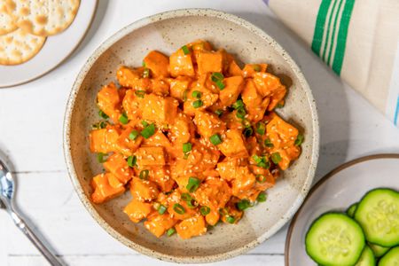 Overhead shot of a plate with gochujang chicken salad topped with chopped scallion