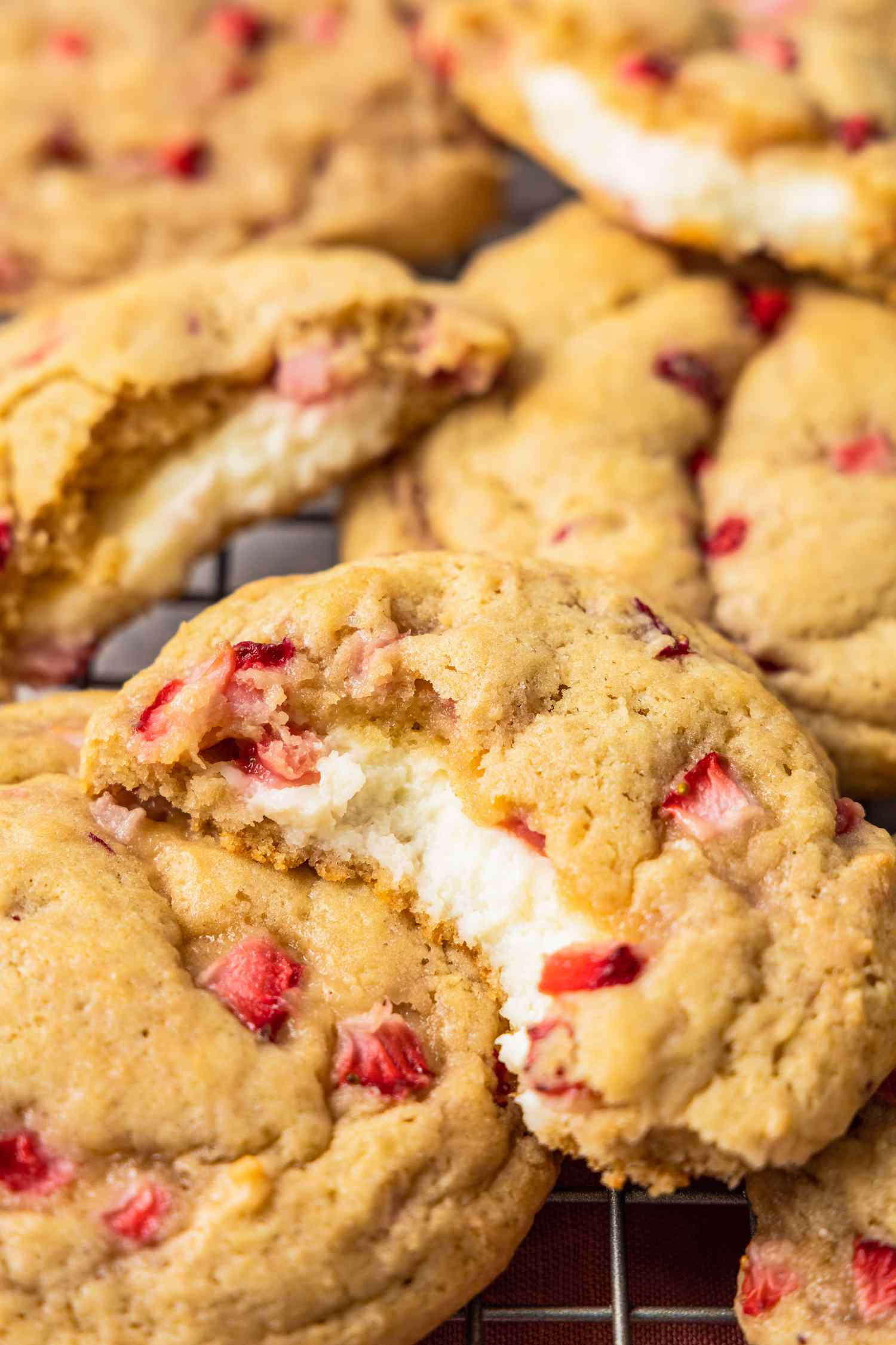 Strawberry Cheesecake Cookies on a Cooling Rack, With Some Cut in Half