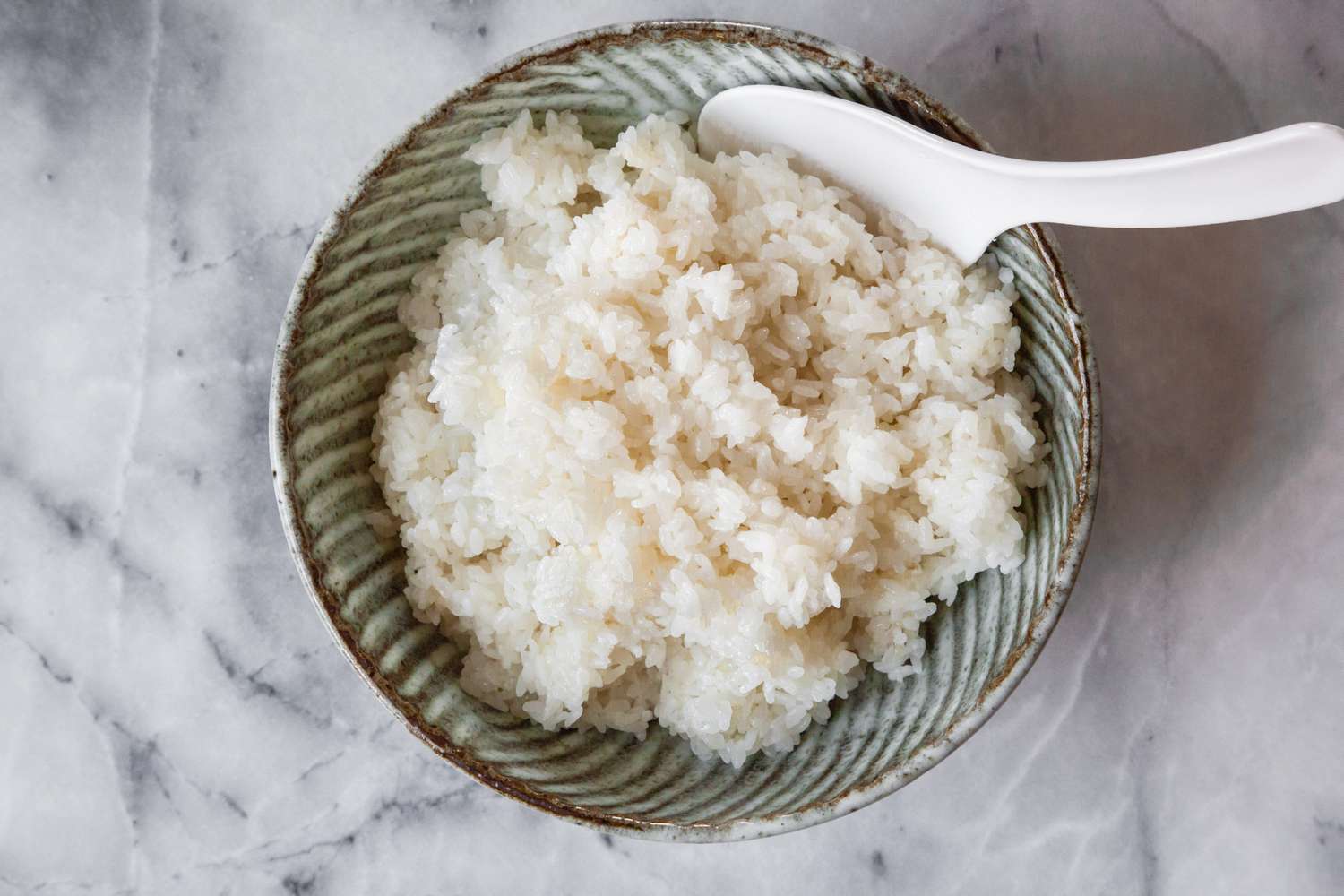 Sushi Rice in a Bowl with a Rice Paddle