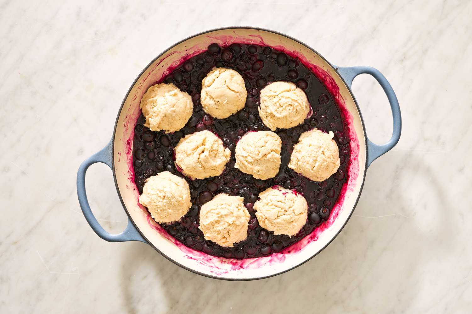 biscuit dough added on top of blueberry filling for blueberry grunt recipe