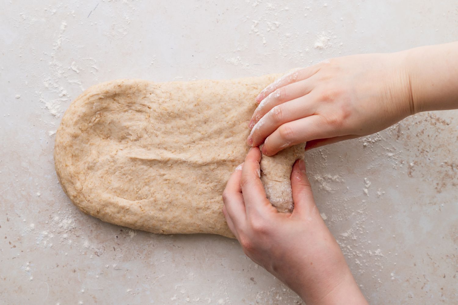 Shaping homemade oat bread.