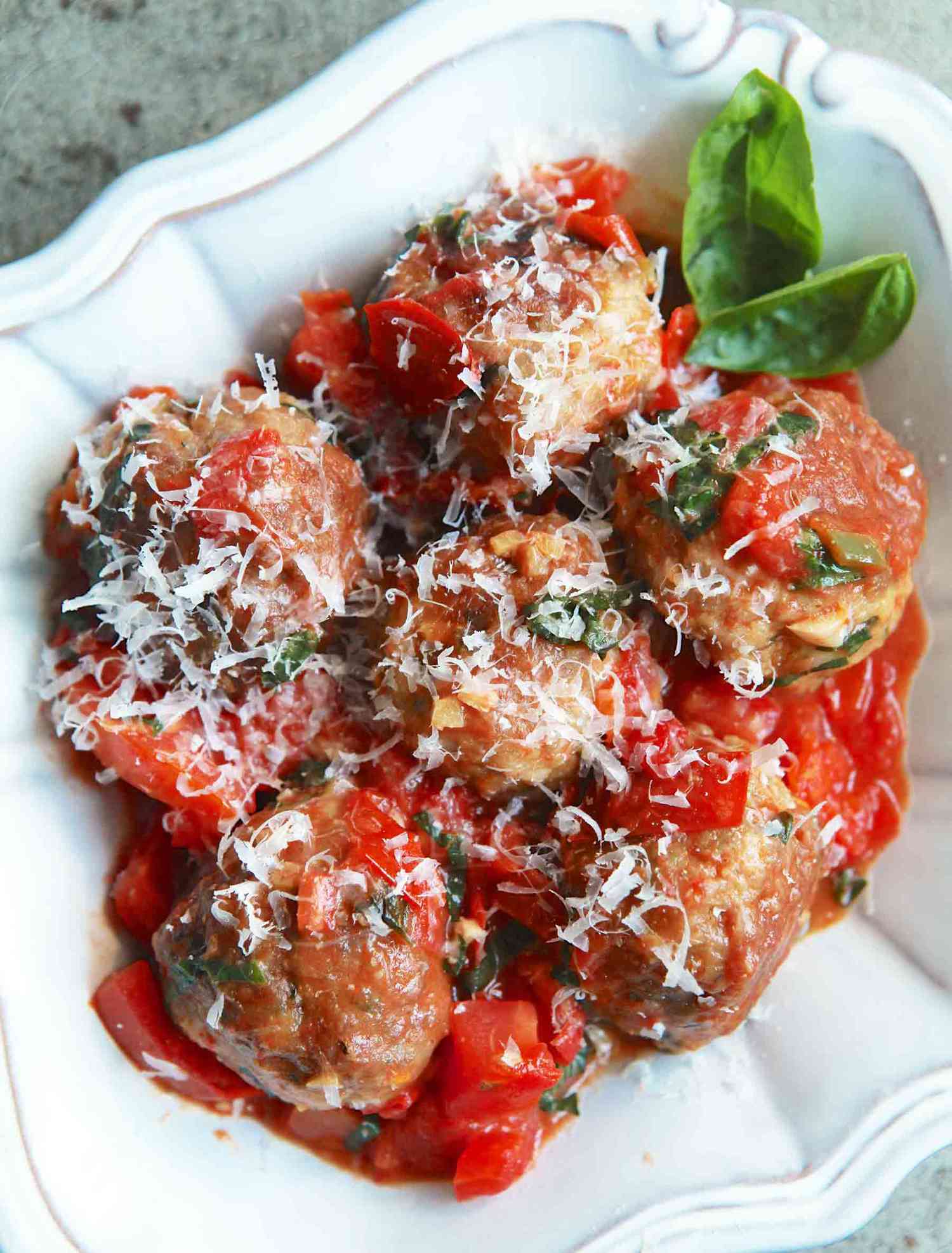 Turkey Meatballs with Tomatoes and Basil in a white bowl