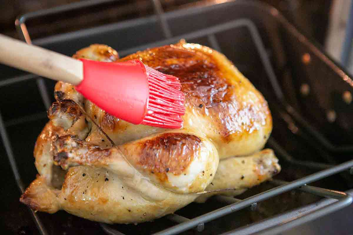 basting a lemon chicken with honey glaze