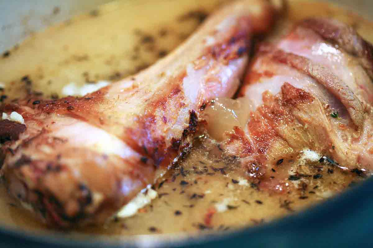 browned lamb shanks in pot